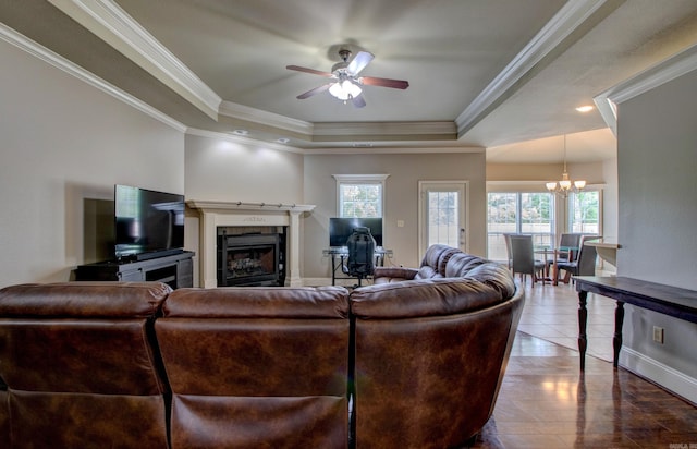 76 Woodridge Dr, Little Rock, AR 72204 - living area featuring a raised ceiling, healthy amount of natural light, a fireplace, ceiling fan, and crown molding