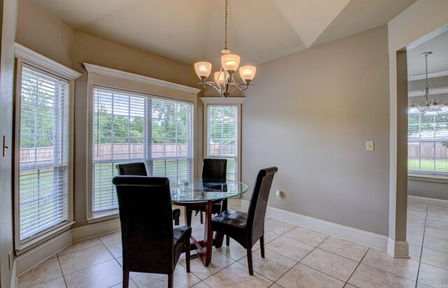 76 Woodridge Dr, Little Rock, AR 72204 - dining space with a chandelier, vaulted ceiling, baseboards, and light tile patterned flooring