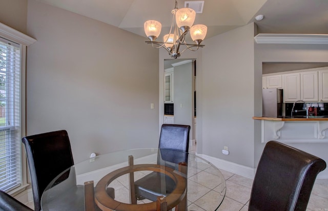 76 Woodridge Dr, Little Rock, AR 72204 - dining room featuring a chandelier, light tile patterned flooring, baseboards, and vaulted ceiling