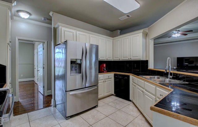 76 Woodridge Dr, Little Rock, AR 72204 - kitchen with appliances with stainless steel finishes, a sink, crown molding, tasteful backsplash, and white cabinetry