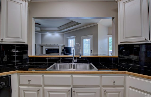 76 Woodridge Dr, Little Rock, AR 72204 - kitchen featuring crown molding, a sink, backsplash, open floor plan, and a raised ceiling