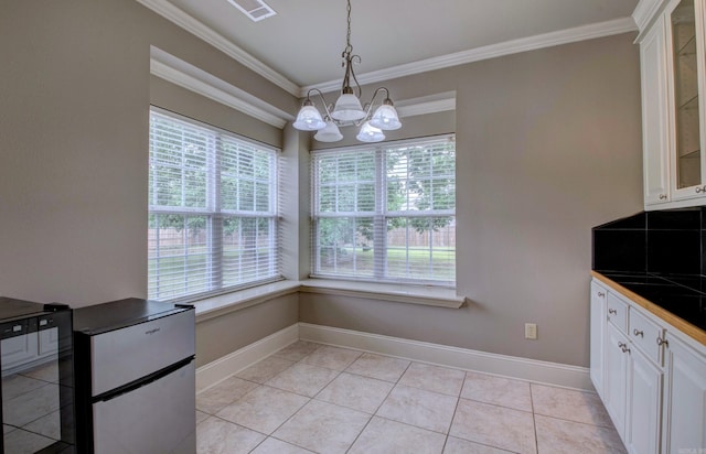 76 Woodridge Dr, Little Rock, AR 72204 - unfurnished dining area with a chandelier, crown molding, baseboards, and light tile patterned flooring