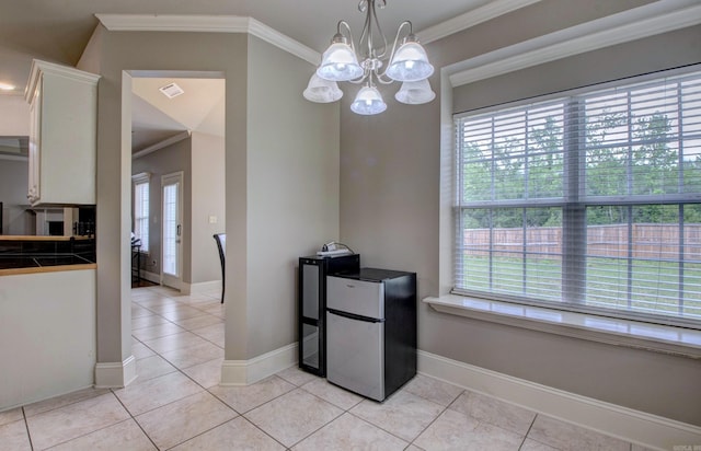 76 Woodridge Dr, Little Rock, AR 72204 - kitchen with freestanding refrigerator, white cabinetry, light tile patterned floors, crown molding, and a chandelier