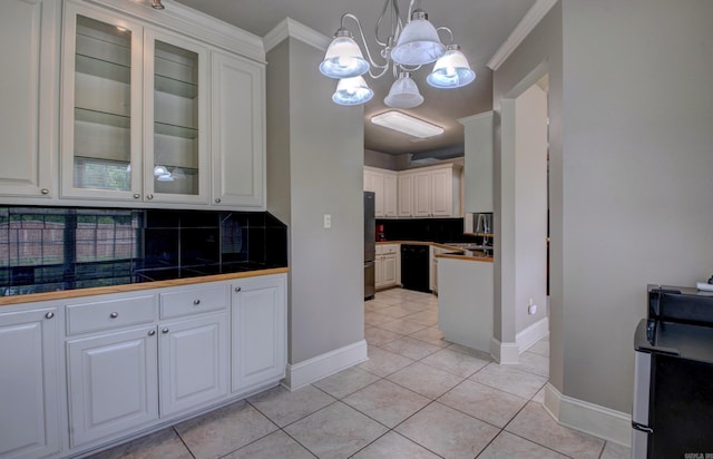 76 Woodridge Dr, Little Rock, AR 72204 - kitchen with freestanding refrigerator, backsplash, white cabinetry, a chandelier, and ornamental molding
