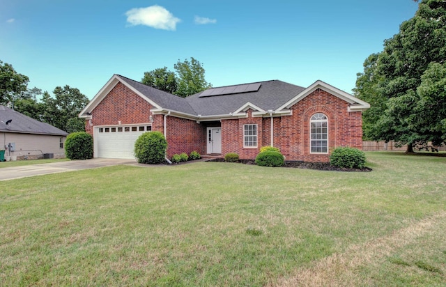 76 Woodridge Dr, Little Rock, AR 72204 - ranch-style home with brick siding, solar panels, an attached garage, and a front yard