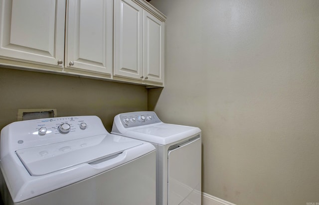 76 Woodridge Dr, Little Rock, AR 72204 - laundry area featuring cabinet space, washing machine and clothes dryer, and baseboards