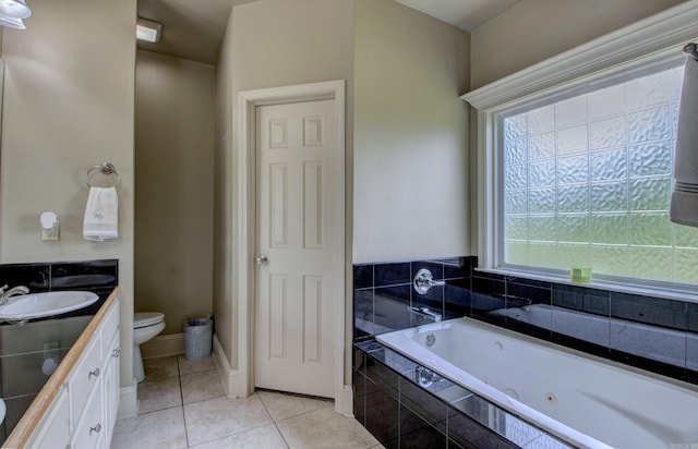 76 Woodridge Dr, Little Rock, AR 72204 - bathroom with toilet, double vanity, a tub with jets, tile patterned flooring, and baseboards