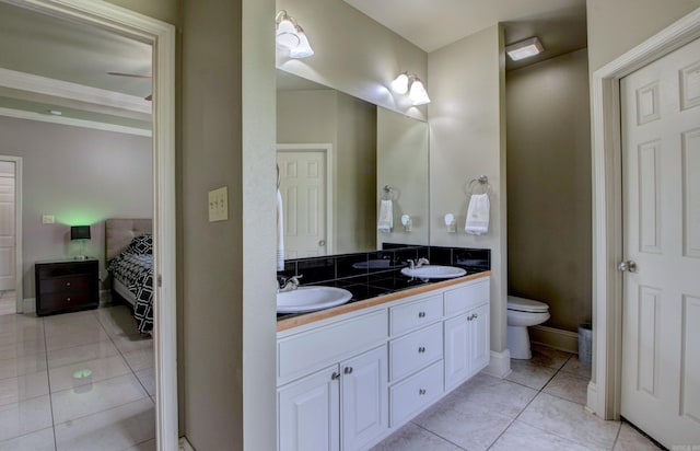 76 Woodridge Dr, Little Rock, AR 72204 - bathroom featuring toilet, double vanity, tile patterned floors, and ensuite bath