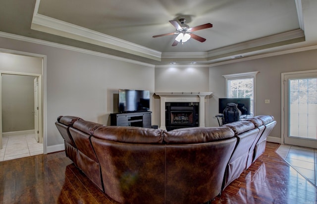 76 Woodridge Dr, Little Rock, AR 72204 - living area featuring a raised ceiling, hardwood / wood-style flooring, a fireplace, a ceiling fan, and baseboards