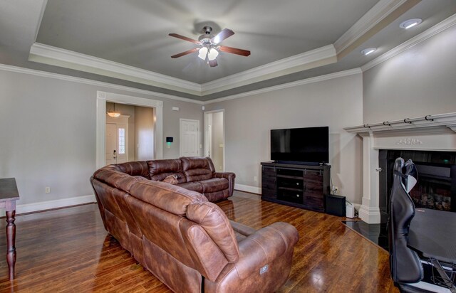 76 Woodridge Dr, Little Rock, AR 72204 - living room featuring a tray ceiling, baseboards, wood finished floors, ceiling fan, and ornamental molding