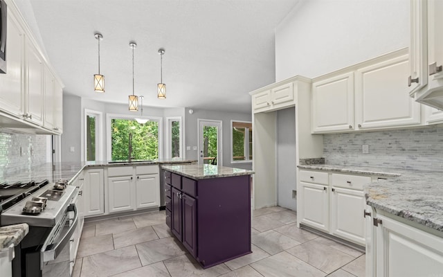 74 Medina Way, Hot Springs Village, AR 71909 - kitchen featuring stainless steel range with gas cooktop, backsplash, white cabinetry, decorative light fixtures, and light stone counters