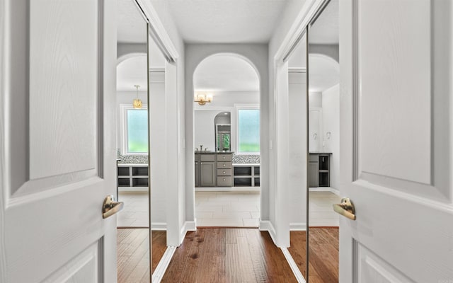 74 Medina Way, Hot Springs Village, AR 71909 - hallway featuring arched walkways and dark wood finished floors