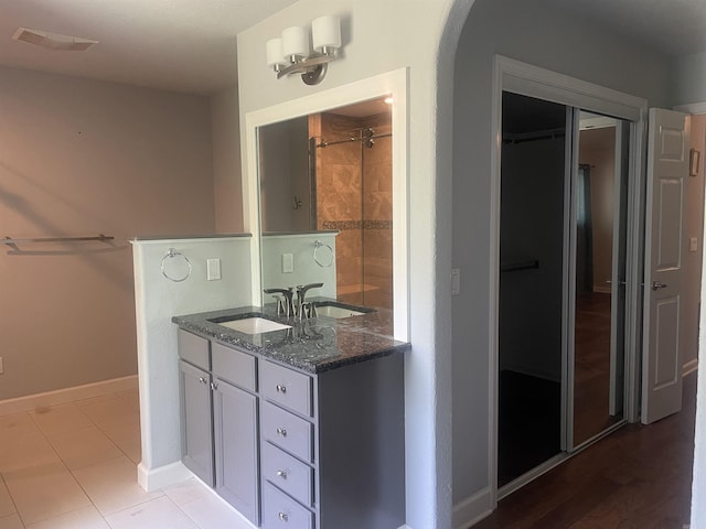 74 Medina Way, Hot Springs Village, AR 71909 - bathroom featuring baseboards, double vanity, and tile patterned floors