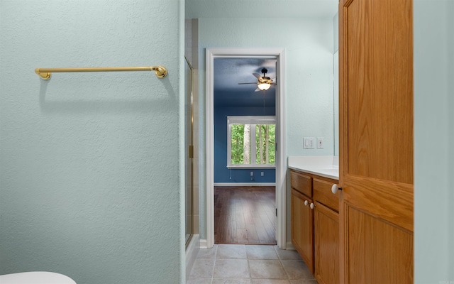 74 Medina Way, Hot Springs Village, AR 71909 - bathroom with a stall shower, vanity, a textured wall, tile patterned floors, and toilet