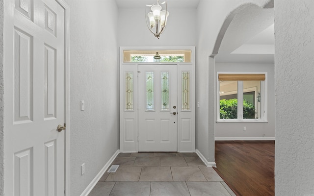 74 Medina Way, Hot Springs Village, AR 71909 - tiled foyer entrance featuring a textured wall, a chandelier, and baseboards