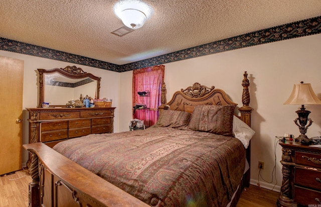 32 Bonnie Park Dr, Pine Bluff, AR 72601 - bedroom featuring wood finished floors and a textured ceiling