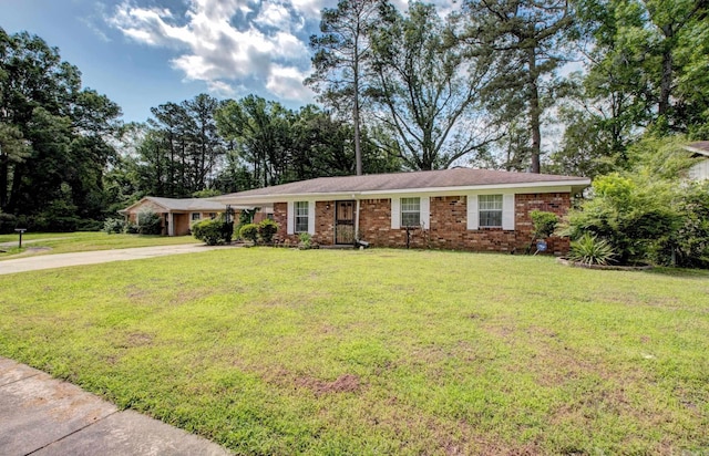 32 Bonnie Park Dr, Pine Bluff, AR 72601 - ranch-style house with concrete driveway, a front lawn, brick siding, and a carport
