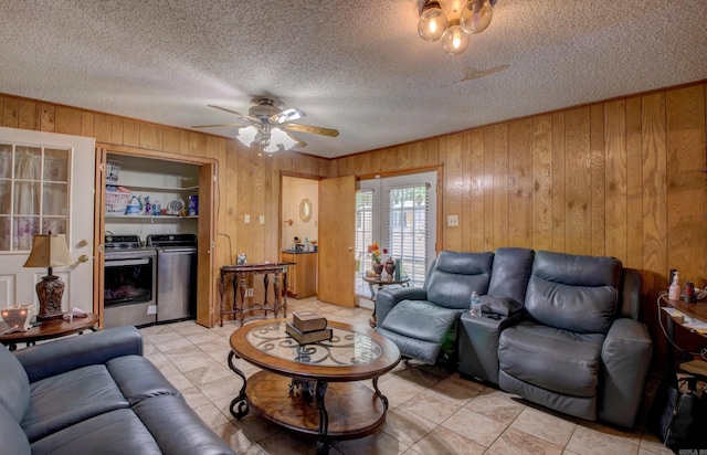 32 Bonnie Park Dr, Pine Bluff, AR 72601 - living room featuring washer and clothes dryer, wooden walls, ceiling fan, a textured ceiling, and light tile patterned floors