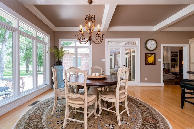 18 Chenal Cir, Little Rock, AR 72223 - dining room featuring a chandelier, plenty of natural light, light wood-type flooring, crown molding, and baseboards