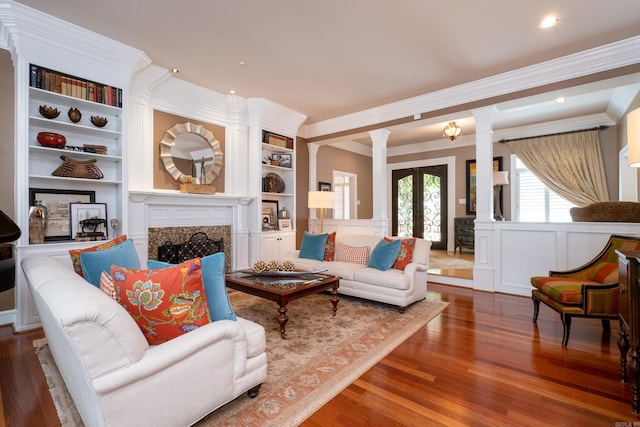 18 Chenal Cir, Little Rock, AR 72223 - living area with ornate columns, wood finished floors, ornamental molding, built in shelves, and a high end fireplace