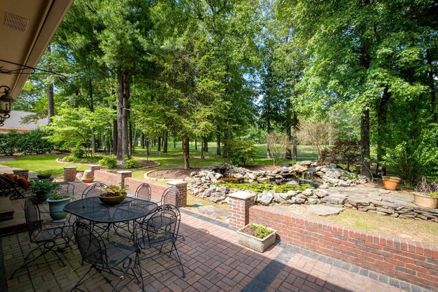 18 Chenal Cir, Little Rock, AR 72223 - view of patio / terrace with outdoor dining area and view of scattered trees
