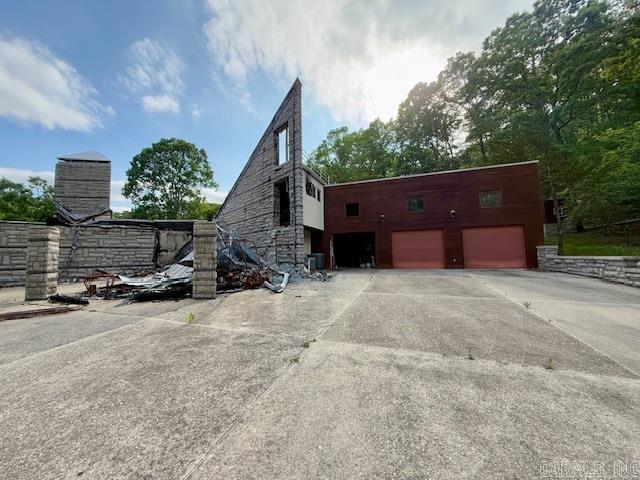 view of property exterior with driveway and a garage