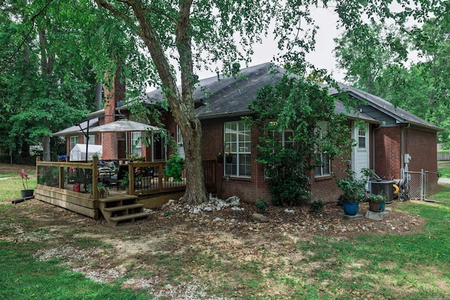 15 Edgewood Dr, Arkadelphia, AR 71923 - rear view of house with brick siding, a deck, and central AC unit