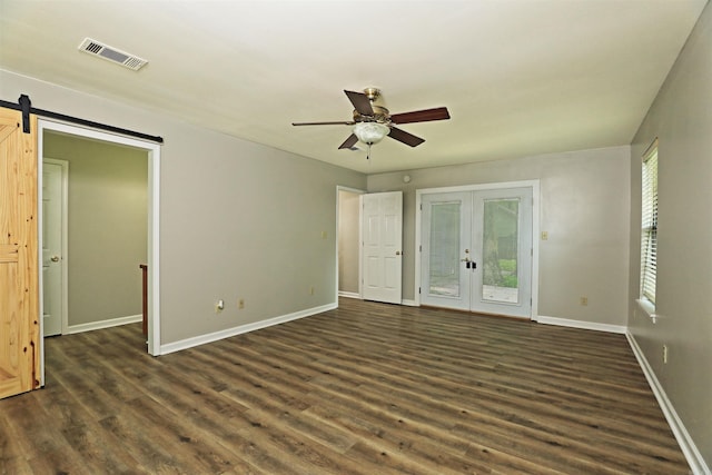 1309 Frontier, White Hall, AR 71602 - unfurnished bedroom with french doors, access to outside, dark wood finished floors, baseboards, and a barn door