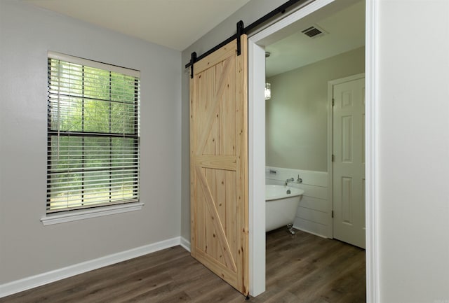 1309 Frontier, White Hall, AR 71602 - full bathroom featuring a freestanding tub, wood finished floors, and baseboards