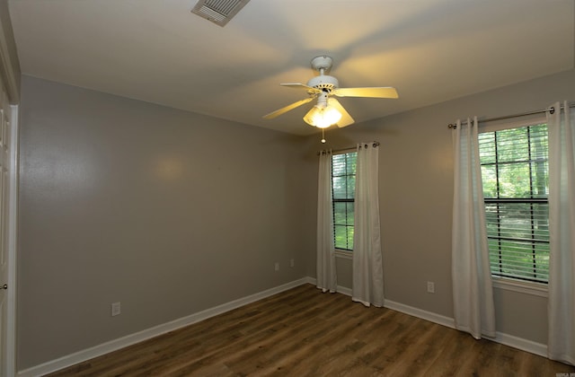 1309 Frontier, White Hall, AR 71602 - unfurnished room with plenty of natural light, dark wood-style flooring, ceiling fan, and baseboards