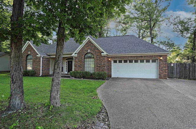 1309 Frontier, White Hall, AR 71602 - view of front of property with asphalt driveway, brick siding, a shingled roof, and a garage