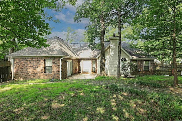 1309 Frontier, White Hall, AR 71602 - back of property featuring a chimney, brick siding, a patio area, and roof with shingles