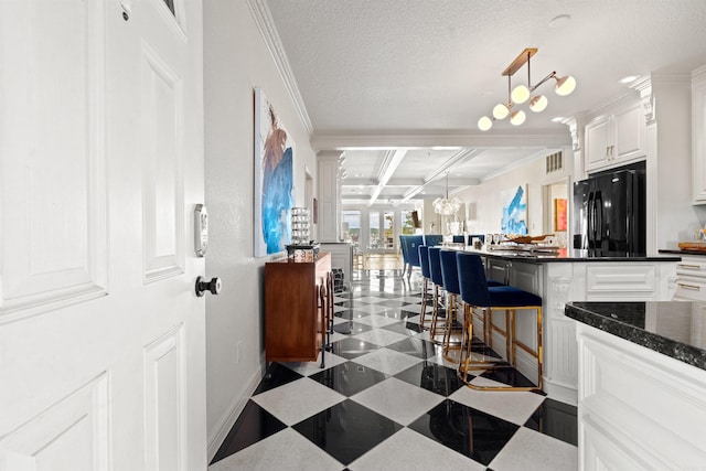130 Grand Isle Dr Unit 1D, Hot Springs, AR 71913 - kitchen featuring freestanding refrigerator, coffered ceiling, beam ceiling, white cabinetry, and a chandelier