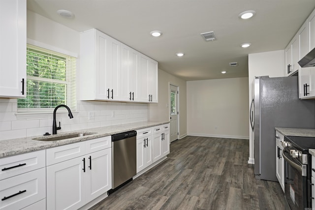 904 W Holland, White Hall, AR 71602 - kitchen with stainless steel appliances, a sink, decorative backsplash, dark wood finished floors, and recessed lighting