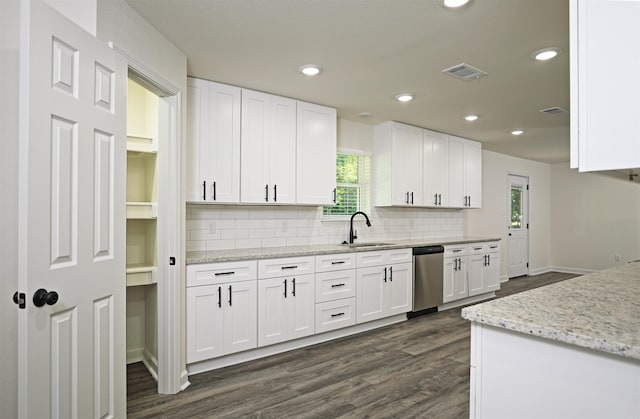 904 W Holland, White Hall, AR 71602 - kitchen featuring a sink, stainless steel dishwasher, tasteful backsplash, dark wood-style flooring, and white cabinets