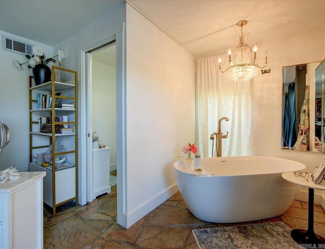 366-370 Restful Ridge Rd, Hot Springs, AR 71913 - bathroom with a freestanding tub, a chandelier, and stone finish flooring