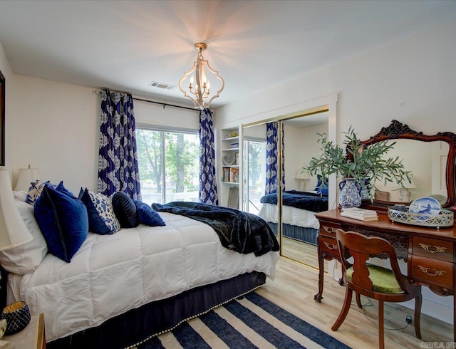 366-370 Restful Ridge Rd, Hot Springs, AR 71913 - bedroom with a chandelier, light wood-type flooring, and a closet