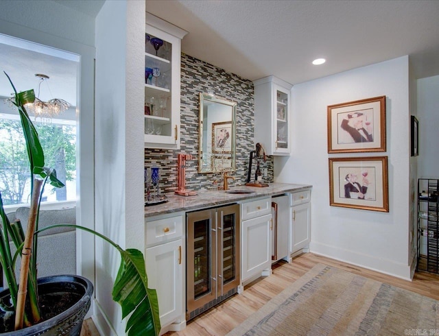366-370 Restful Ridge Rd, Hot Springs, AR 71913 - indoor wet bar featuring beverage cooler, decorative backsplash, light wood-style floors, recessed lighting, and baseboards