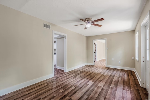 1907 Creekwood Dr, Conway, AR 72032 - unfurnished room featuring ceiling fan, dark wood-style floors, and baseboards