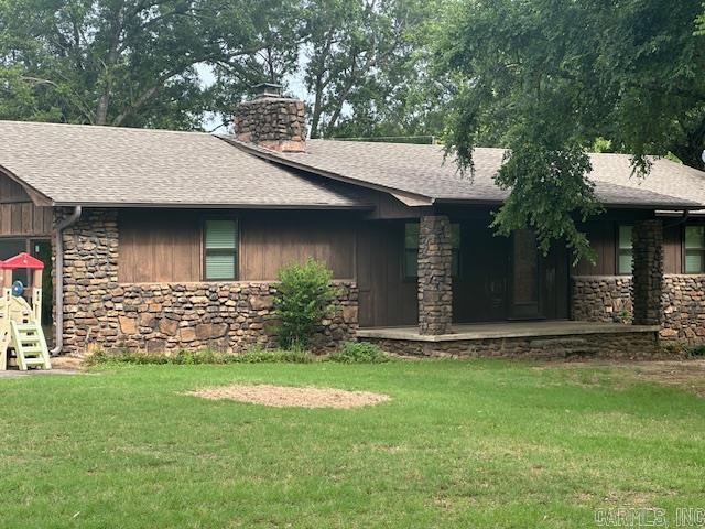 1 Rogers Dr, Morrilton, AR 72110 - ranch-style house featuring stone siding, a chimney, a shingled roof, and a front lawn