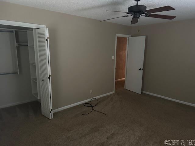 1 Rogers Dr, Morrilton, AR 72110 - unfurnished bedroom with carpet flooring, a closet, baseboards, a textured ceiling, and a ceiling fan