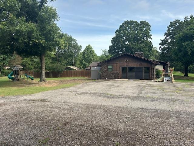 1 Rogers Dr, Morrilton, AR 72110 - garage featuring asphalt driveway and view of wooded area