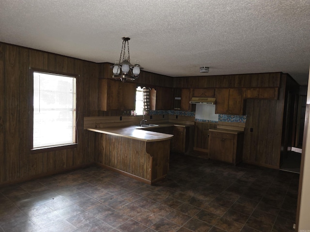 85 Bailey Rd, Morrilton, AR 72110 - kitchen with a peninsula, a textured ceiling, wood walls, extractor fan, and light countertops