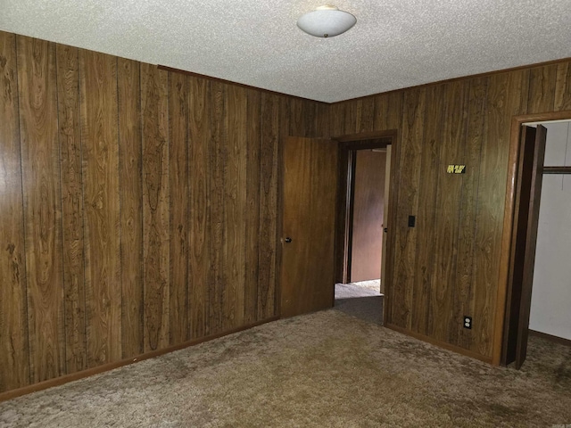 85 Bailey Rd, Morrilton, AR 72110 - carpeted spare room featuring wooden walls and a textured ceiling
