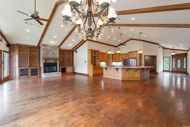 261 Peninsula Dr, Hot Springs, AR 71901 - unfurnished living room with high vaulted ceiling, beamed ceiling, ceiling fan, a fireplace, and dark wood finished floors