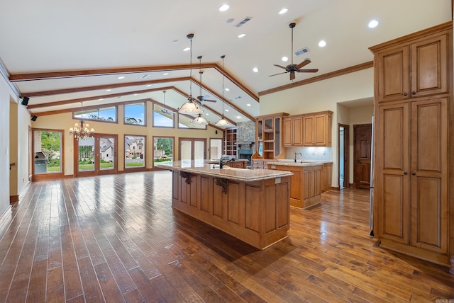 261 Peninsula Dr, Hot Springs, AR 71901 - kitchen featuring an island with sink, ceiling fan, a chandelier, open floor plan, and brown cabinetry
