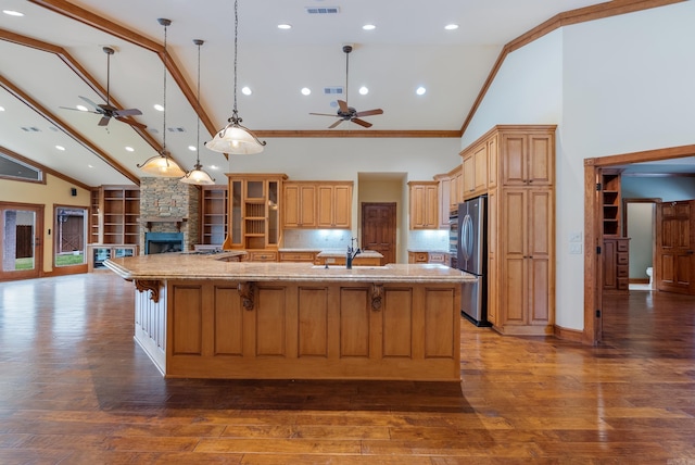 261 Peninsula Dr, Hot Springs, AR 71901 - kitchen featuring ceiling fan, high vaulted ceiling, freestanding refrigerator, a fireplace, and a spacious island