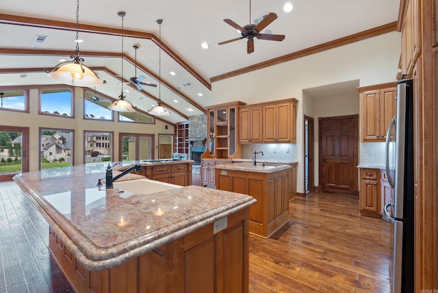 261 Peninsula Dr, Hot Springs, AR 71901 - kitchen with a large island, ceiling fan, a sink, brown cabinets, and freestanding refrigerator