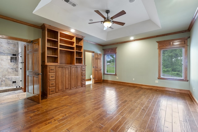 261 Peninsula Dr, Hot Springs, AR 71901 - unfurnished living room featuring a tray ceiling, wood-type flooring, a ceiling fan, crown molding, and baseboards