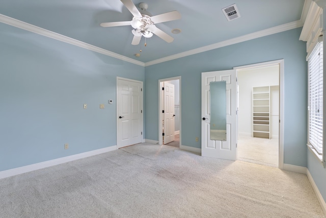 261 Peninsula Dr, Hot Springs, AR 71901 - unfurnished bedroom with a walk in closet, crown molding, carpet, baseboards, and multiple windows
